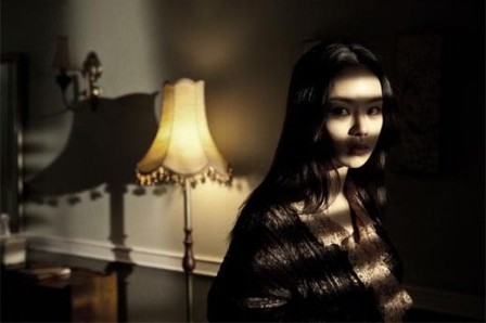 Woman by Blinds